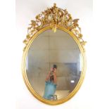 An early 19th century giltwood mirror, the top with putto and birds amidst foliage and scrolls