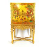 An early 20th century, 18th century style chinoiserie cabinet on stand, the gold lacquered cabinet