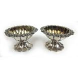 A pair of George IV silver pedestal salts of reeded form. Hallmarked for London 1827, makers mark