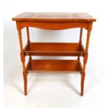 A reproduction early 19th century style satinwood library table, the serpentine top over two book