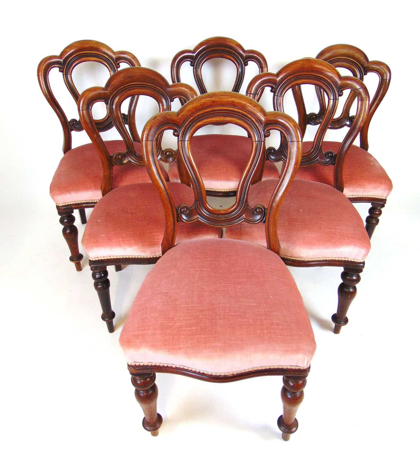 A set of six Victorian mahogany dining chairs, the moulded backs over the serpentine seat