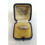 An 18ct gold and five stone diamond fine, the old cut stones in a channel setting. Approx weight 6.