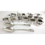 A large assortment of silver and white metal items to include small pouring jugs, bowl, table