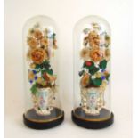 A pair of early 20th century continental ceramic posy holders under glass domes, h. 42 cm