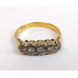 A yellow metal five stone diamond ring marked '18ct', the stones mounted in an illusion setting.