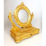 A 19th century French giltwood toilet mirror, the circular plate on foliate scroll supports above
