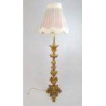 A late 19th century gilt brass standard lamp converted from an oil lamp, with cherub design, h.