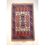 A handwoven Turkish rug, the three line border surrounding a cream ground field with geometric