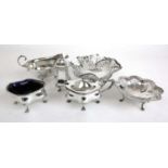 A selection of silver tableware to include a three piece cruet set, sauce boat and two bon-bon