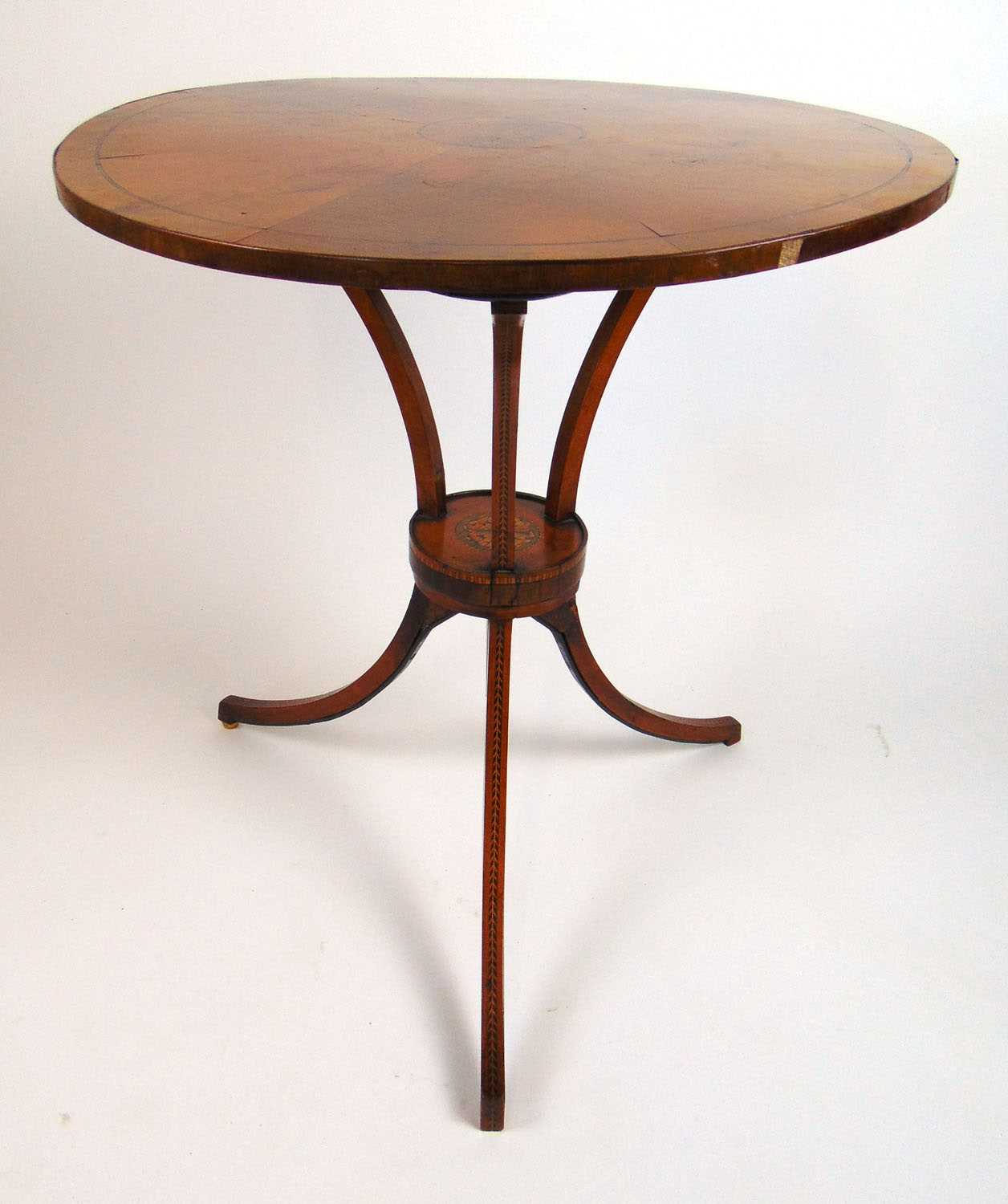 An 18th century satinwood and inlaid gueridon/occasional table, the circular top over three C-scroll