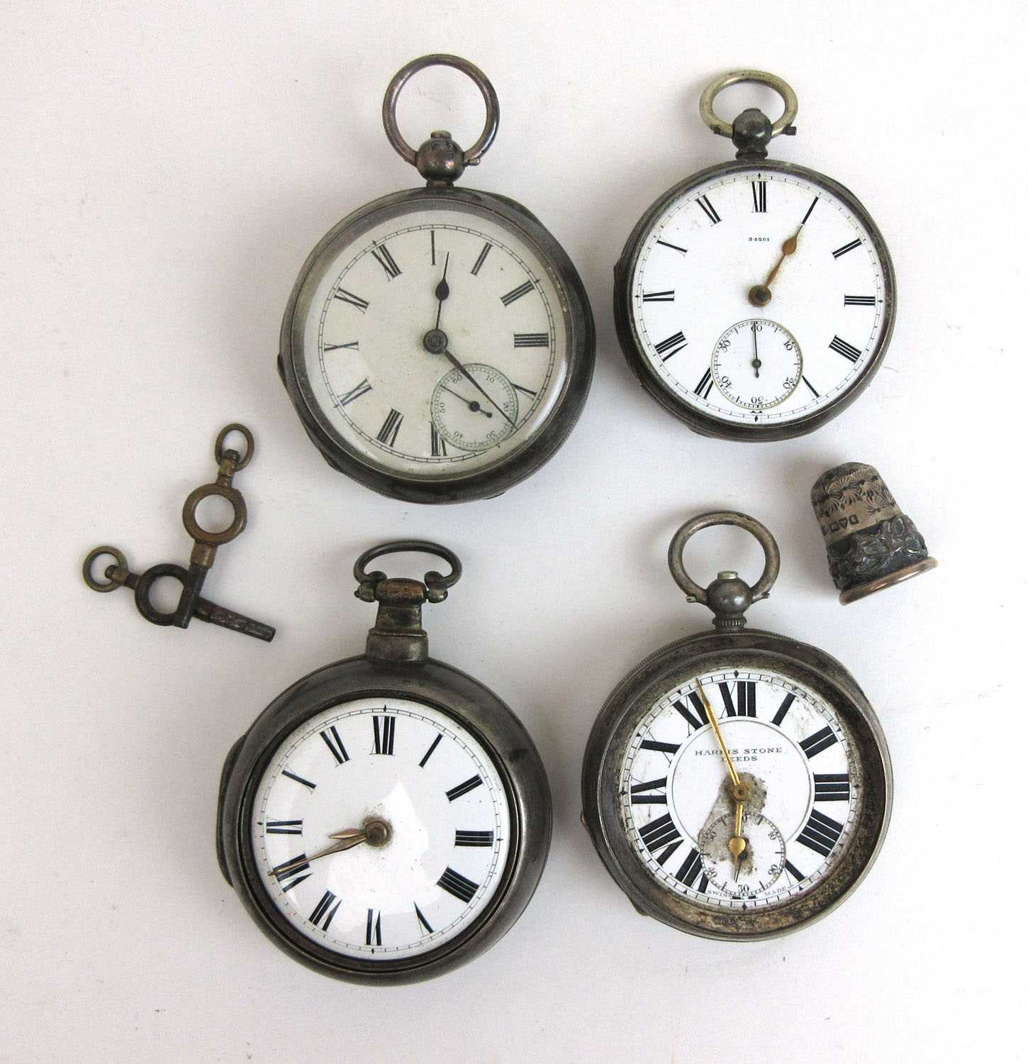 A collection of four silver pocket watches (and one thimble) to include a pair cased verge fusee