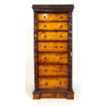 A 19th century style mahogany and birch wellington chest, the carved edged top over seven drawers on