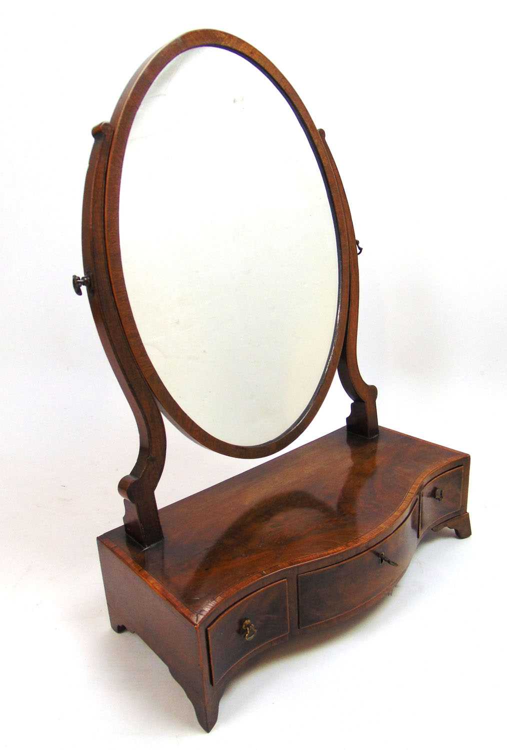 A Regency mahogany, boxwood strung and rosewood banded toilet mirror, the oval plate over the