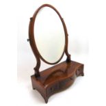 A Regency mahogany, boxwood strung and rosewood banded toilet mirror, the oval plate over the