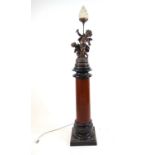 A 19th century French lamp on column, the spelter cherubs on the ebonized and carved column, h.