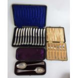 A selection of cased silver flatware to include pistol handled knives, silver cake fork set and a