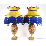 A pair of early 20th century purple marble and gilt brass mounted lamps, the columns with green