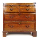 An 18th century oak and banded bachelor's chest, the fold over top over one long, two short and