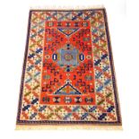A handwoven Turkish rug, the multi line border surrounding a peach ground field with geometric