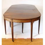 An 18th century and later mahogany D-end dining table, the two D-ends incorporating a drop leaf
