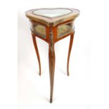 A 19th century French mahogany and brass mounted vitrine table, the heart shaped glazed top on