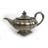 A George IV silver teapot of squat form. Hallmarked for London 1829, makers mark for William Ker