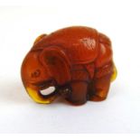 A Japanese Meiji period carved amber type netsuke in the form of an elephant, h. 2.5 cm