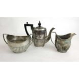 A George V silver coffee pot of small proportions together with a Edwardian silver cream jug and