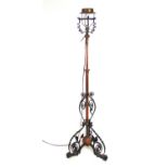 A 19th century wrought iron and copper adjustable standard lamp converted to electricity, max h.
