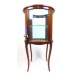 An Edwardian mahogany, boxwood strung and marquetry cylindrical vitrine, with single door on swept