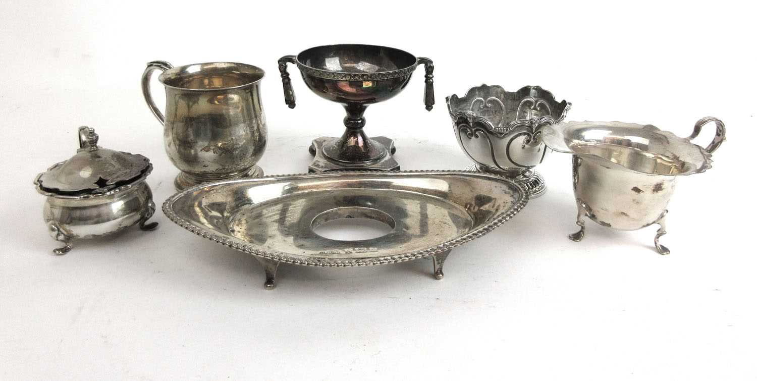 An assortment of silver items to include an inkstand, trophy, mug, small rose bowl etc. Various
