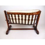 A 18th century Dutch walnut and marquetry crib, the pleated silk lined swing basket on turned