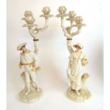 A pair of Royal Worcester Hadley style figural candelabra modelled as a country gentleman with