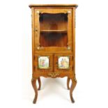 A 19th century walnut and gilt brass mounted display cabinet, the serpentine top over the single