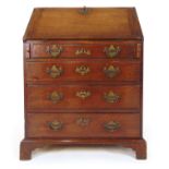 A mid 18th century mahogany bureau, the fall front with fitted interior over four long drawers on