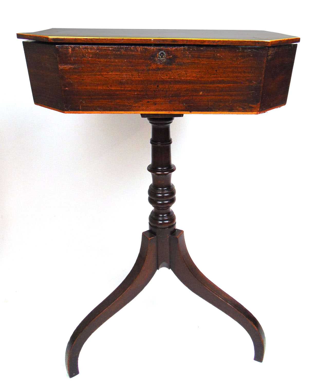 An 18th century mahogany and oak banded work table, the top lifting to reveal a silk lined