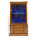 A 19th century rosewood miniature display/collectors cabinet, the glazed door enclosing a fixed