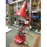 A modern red angle poise style lamp