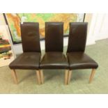 Three modern brown leatherette upholstered dining chairs