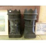 A pair of black plastic faux chimney pots