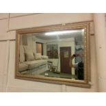 An ornate gilt framed bevel glass mirror