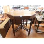 An early 20th century walnut occasional table, the octagonal top on turned legs and galleried