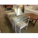 A metal framed glass topped dressing table with matching stool
