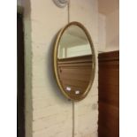 An ornate oval bevel glass mirror