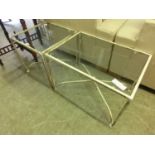 Two matching style occasional tables with metal frames and glass tops, one square and one