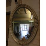 Ornate silvered framed oval mirror