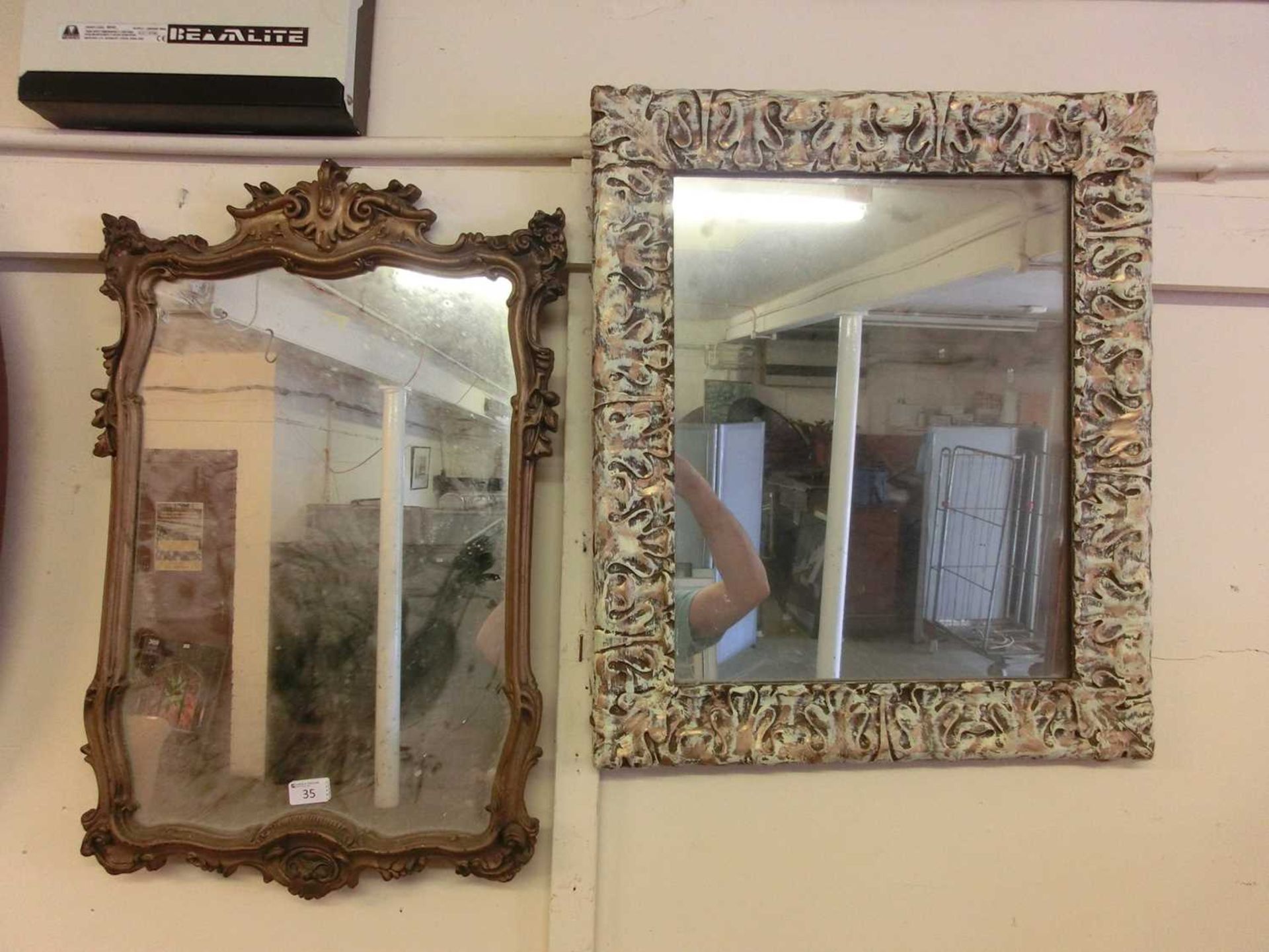 Ornate gilt framed mirror with one other