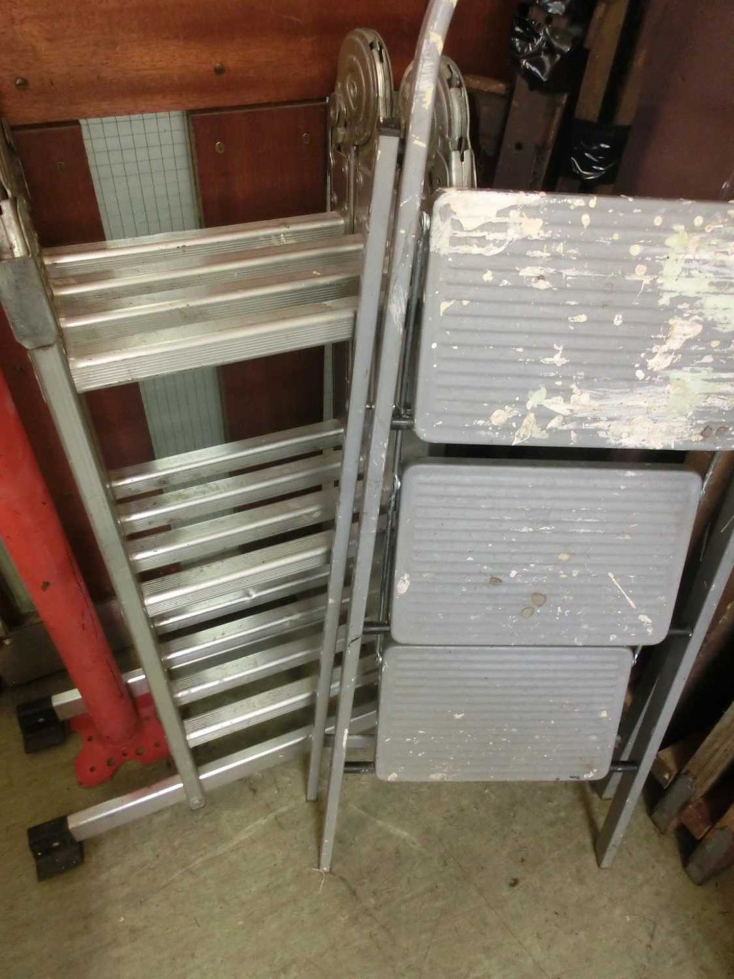 A folding ladder together with a set of aluminium steps