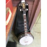 A Samick four string banjo with canvas case