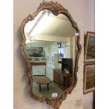 An ornate gilt framed mirror